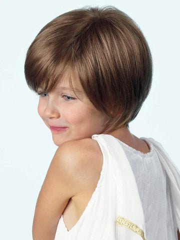 Child model wearing Logan Amore wig for kids short light brown layered bob with side bangs smiling