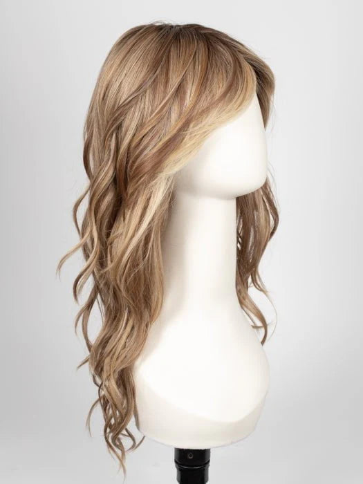 long wavy brown wig for women with blonde highlights and side swept bangs on white mannequin head