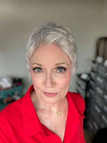 Close up mature woman wearing Ellen Wille Risk wig short silver pixie style red blouse and gold M necklace