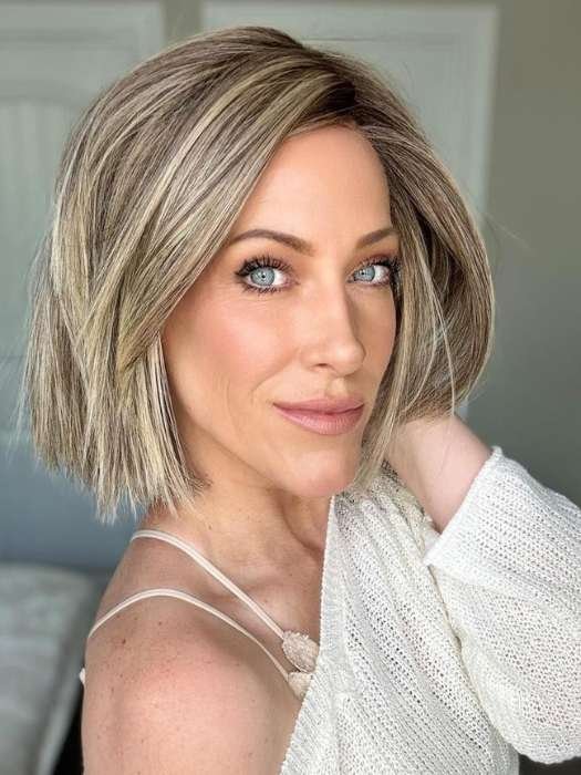 Model wearing short brown bob wig for women with textured layers and blonde highlights in natural style