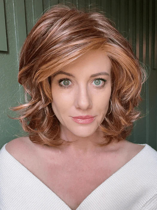 Model wearing Raquel Welch Goddess wig chestnut layered shoulder length bob with soft waves and side sweep